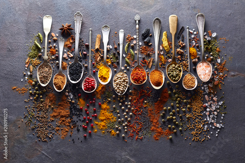 Spices in closeup on graphite board