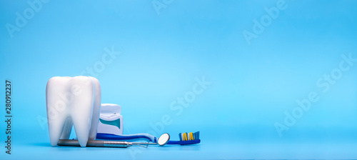White healthy tooth, different dentist tools for dental care. Dental banner or background.- Image