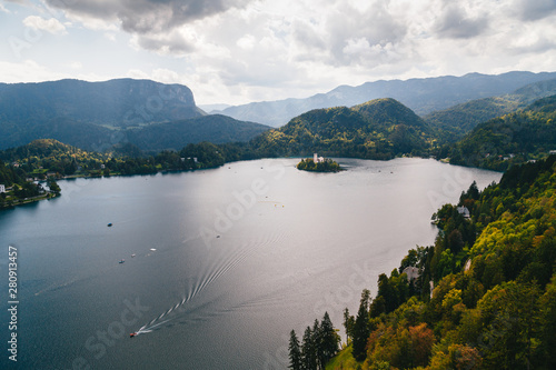 Aerial view of the lake Bled in Slovenia surrounded by mountains and forests and the Bled island. With resorts, hotels, houses, parks and beaches located on the banks of the lake. Travel concept © Iryna Budanova