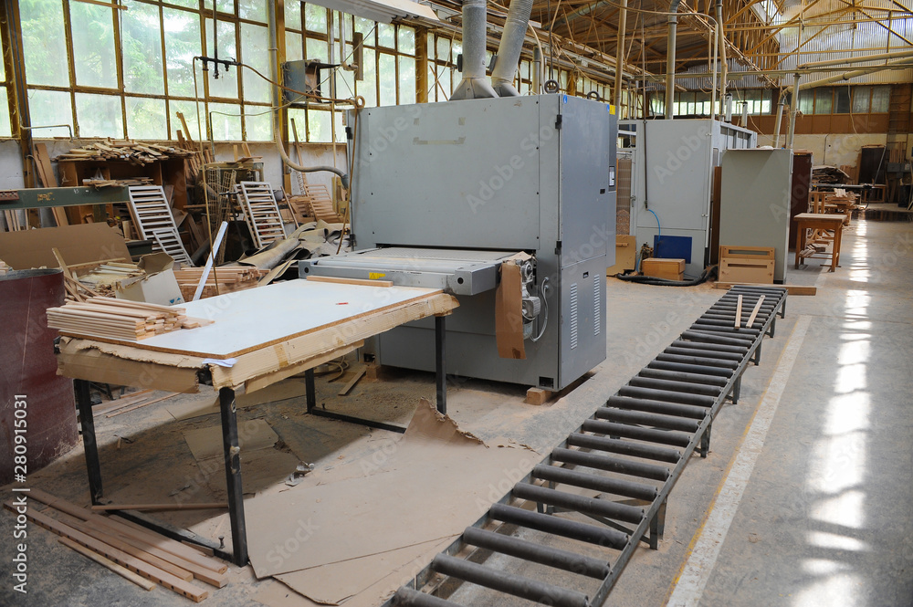 Naklejka premium Wood processing machines and pieces of products in a furniture factory