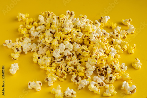 a bunch of popcorn dropped on the color surface flat lay