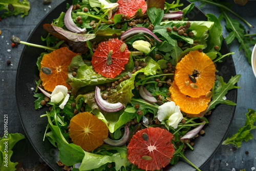 Orange and grapefruit Citrus salad with lentills vertes, wild rocket, arugula, red onion and sprinkle of pumpkin seeds photo