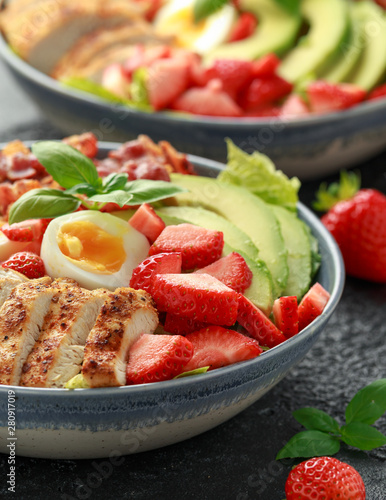 Chicken Cobb salad with strawberries, bacon, avocado and boiled eggs