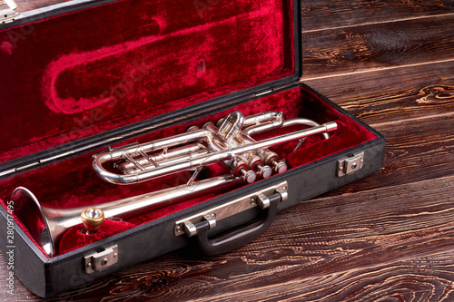 Professional trumpet in velvet case. Brass lacquered trumpet. Classical jazzy instrument. © DenisProduction.com