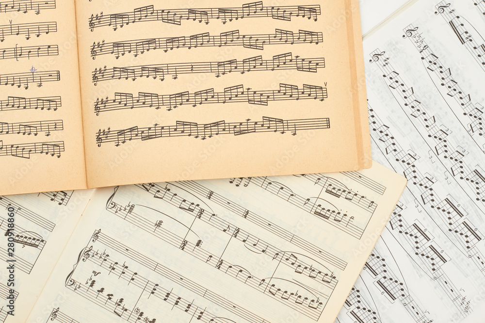 Musical note books close up. Music score sheets close up. Musical note pages background.