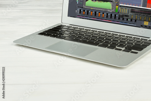 Silver laptop on white surface. Opened pc notebook with blank screen on white background. Modern portable device.