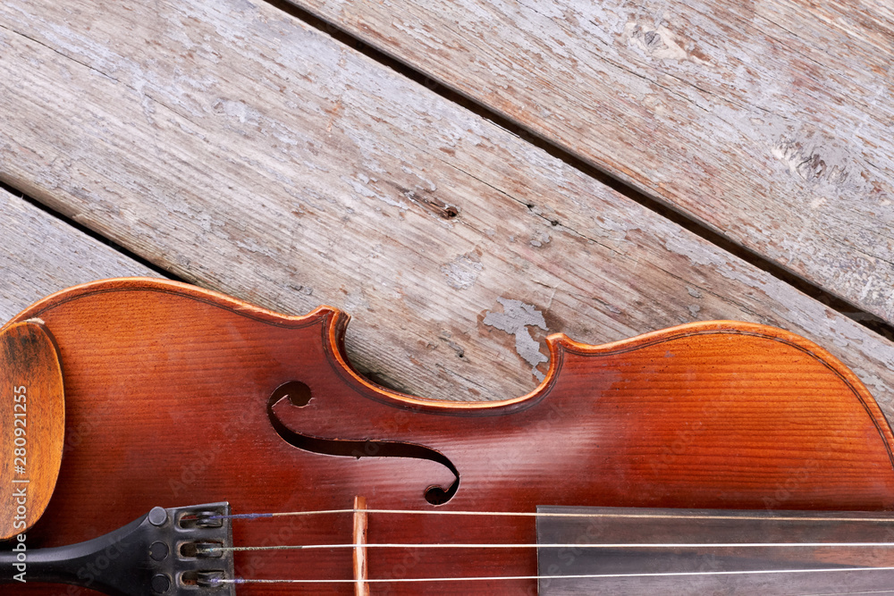 Part of violin and copy space. Retro violin on wooden boards and text space, horizontal image.