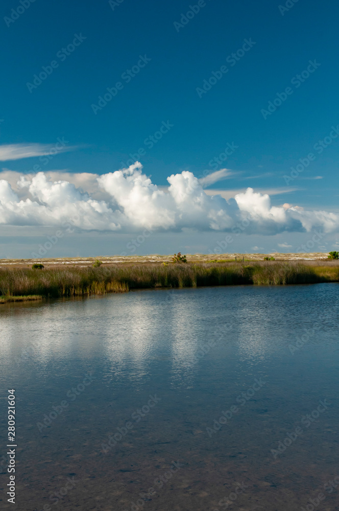 landscape with coastal pond and clouds