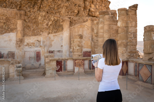 Tableau sur toile Young woman exploring the ruins of masada in israel