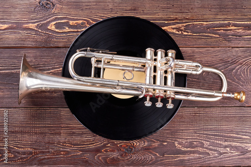Canvas Print Trumpet and vinyl disc on wooden background
