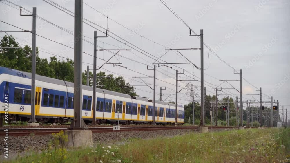Dutch Sprinter train passes in high speed near Utrecht on a sunny day, Utrecht, The Netherlands, July 12th 2019 Dutch Sprinter train passes in high speed near Utrecht on a sunny day, Utrecht, The Netherlands, July 12th 2019