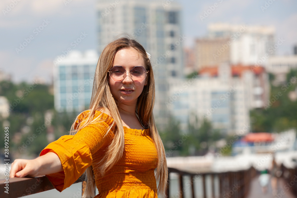 Fototapeta premium Blonde woman looking at camera. Blonde woman with thick eyebrows and blue eyes.