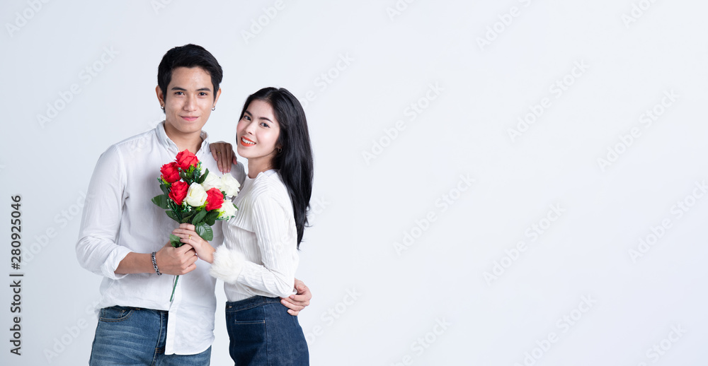 asian beautiful young happy couple man and women hold rose on valentine day with empty copy space asian beautiful young happy couple man and women hold rose on valentine day with empty copy space