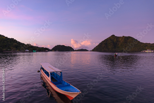 Sunset tropical sea wooden boats at Banda Islands. Indonesia Moluccas archipelago. Top travel destination, best diving snorkeling, volcano.