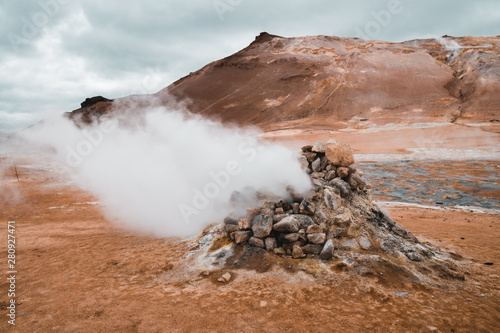 Hverir geothermal area in North Iceland. dy geysers and sulfur field. Orange mountains Iceland.