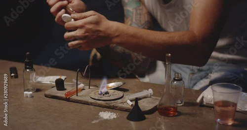 Man heating drug in a spoon