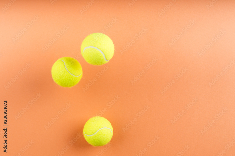 Tennis balls bouncing on orange. Concept