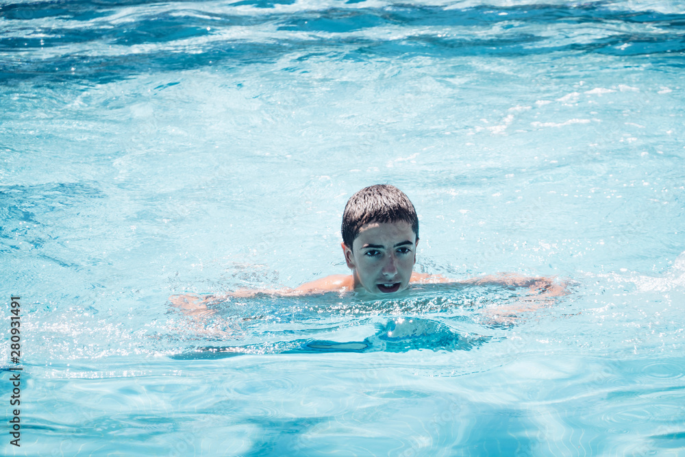 Young teenage boy has fun in swimming pool on his vacation Stock Photo ...
