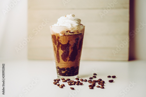 Fotografie, Obraz Ice coffee in the glass topped whipping cream with coffee beans