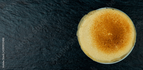 Pancakes in the tray. FISHY TASTY GOLDEN PANCAKES IN THE WHITE CERAMIC PLATE ON A DARK BACKGROUND. VIEW FROM ABOVE. KOPI SPACE photo