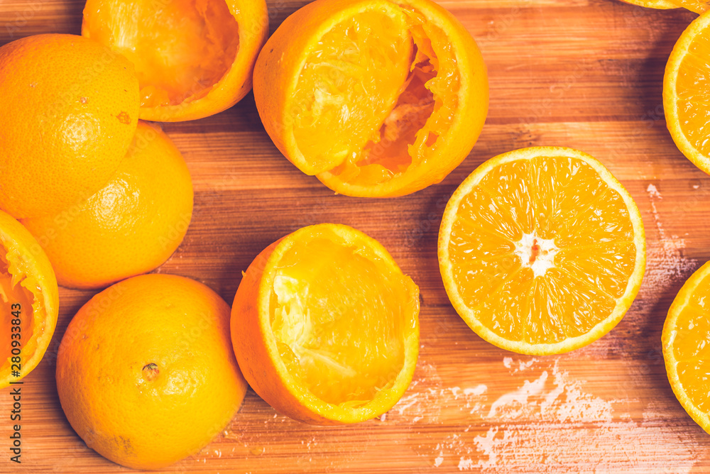 Orange background. Closeup of half cut and squeezed fruits in pattern next to each other Orange background. Closeup of half cut and squeezed fruits in pattern next to each other