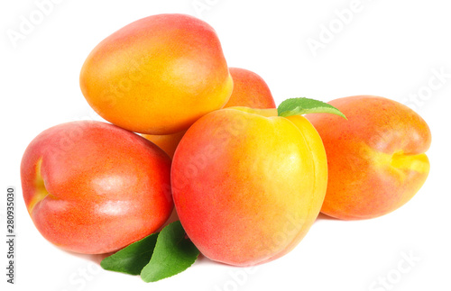 apricot fruits with slices and green leaf isolated on white background