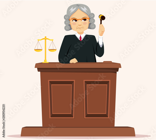 Serious senior male judge with wig holding gavel judging