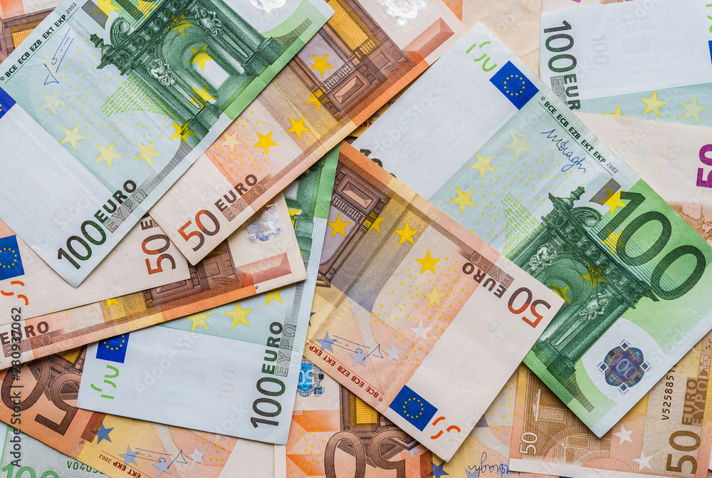 Close up of euro currency, bills of 100 and 50 euros. Concept of finance, business, banking, debt, and European Union. Close up of euro currency, bills of 100 and 50 euros. Concept of finance, business, banking, debt, and European Union.