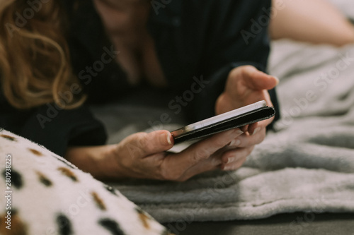 woman with cell phone in the room at home