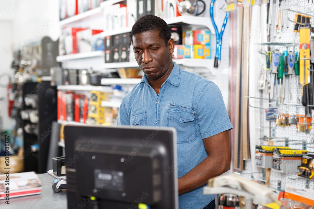 Confident salesman working on computer