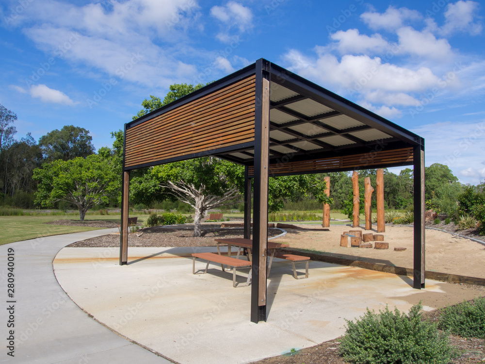Modern pergola and sitting area with play ground behind in Public Park