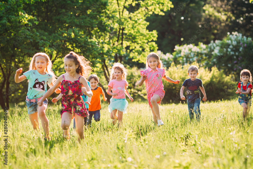 Large group of kids, friends boys and girls running in the park on sunny summer day in casual clothes . Large group of kids, friends boys and girls running in the park on sunny summer day in casual clothes .