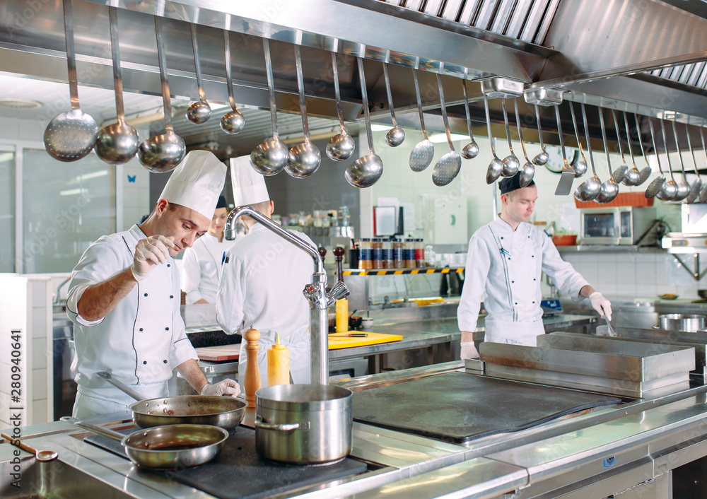 Modern kitchen. The chefs prepare meals in the restaurant's kitchen. Modern kitchen. The chefs prepare meals in the restaurant's kitchen.