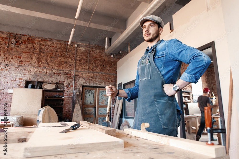 Successful handsome businessman with stylish cap work in carpentry Successful handsome businessman with stylish cap work in carpentry