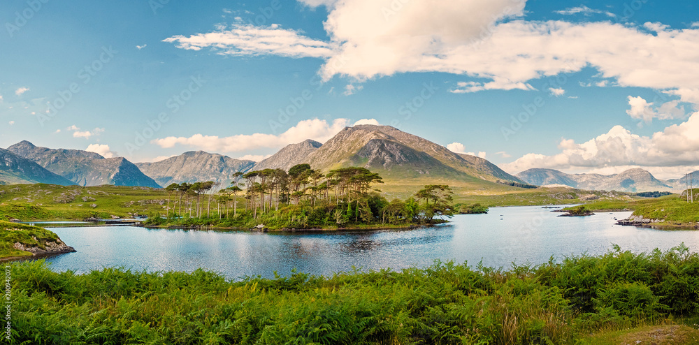 Derryclare Lough, Twelve Pines landscape, Panorama image, Sunny warm day, Cloudy sky, County Galway Ireland.