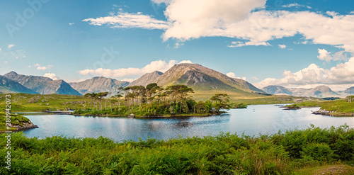 Derryclare Lough  Twelve Pines landscape  Panorama image  Sunny warm day  Cloudy sky  County Galway Ireland.
