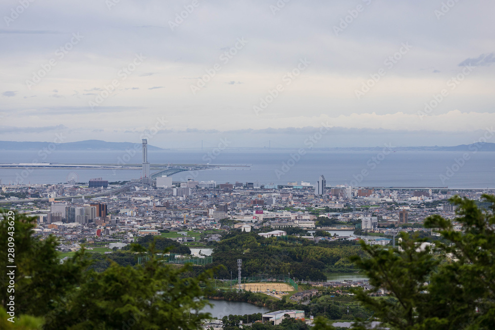 Urban sprawl visible through trees at top of Ameyama, one of the popular lookout points in the area