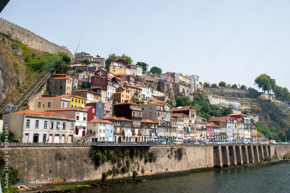 Houses built on the side of a cliff with the funicular off the Douro river in Porto, Portugal