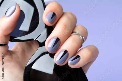 Beautiful woman's nails with geometric minimal manicure