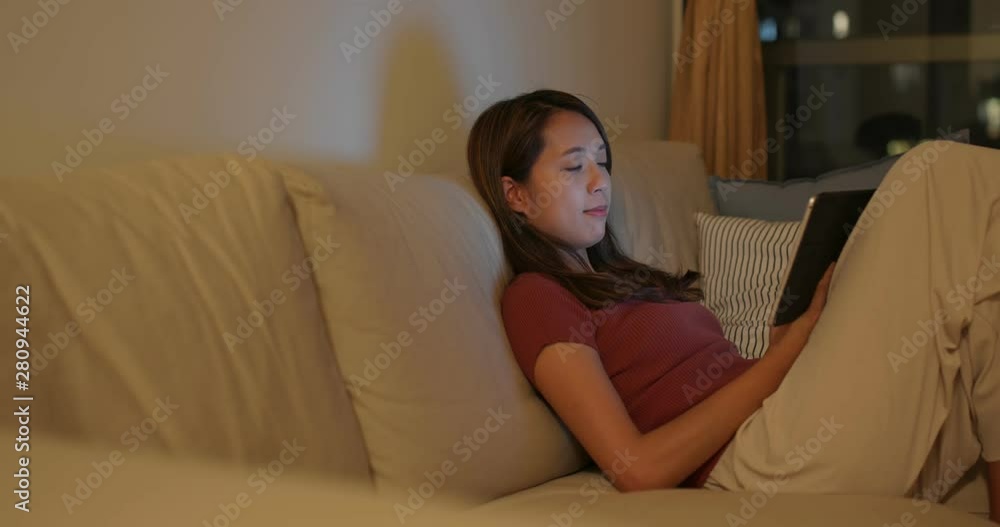 Woman work on tablet computer at night Woman work on tablet computer at night