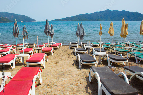 Sun loungers and sea umbrella on the beach by the sea