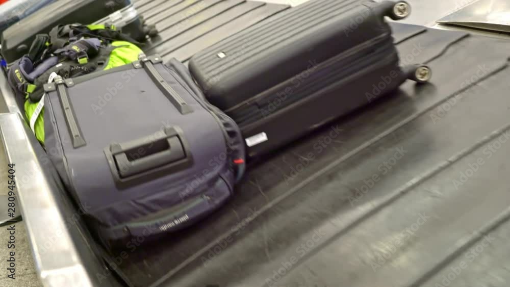 New York, United States, June 10, 2018: Luggage arriving on baggage carousel waiting for travelors at the depature hall of John F. Kennedy airport New York, United States, June 10, 2018: Luggage arriving on baggage carousel waiting for travelors at the depature hall of John F. Kennedy airport