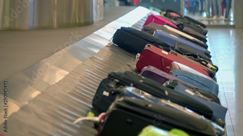 New York, United States, June 10, 2018: Luggage on baggage carousel waiting for travelors at the depature hall of John F. Kennedy airport