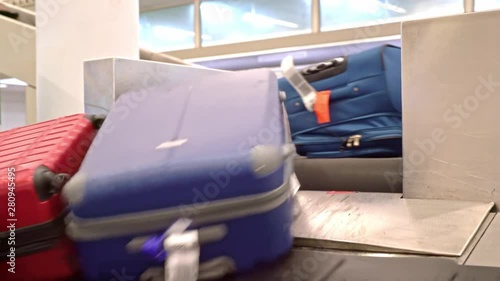 New York, United States, June 10, 2018: Luggage arriving on baggage carousel waiting for travelors at the depature hall of John F. Kennedy airport photo