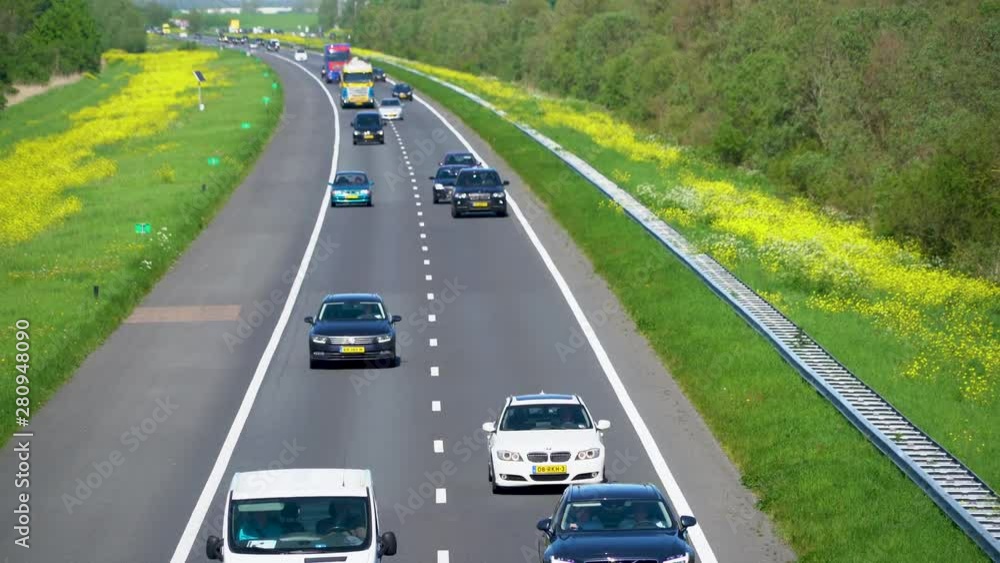 Lelystad, The Netherlands, Cars passing on the busy motorway A6 between Lelystad and Almere Lelystad, The Netherlands, Cars passing on the busy motorway A6 between Lelystad and Almere