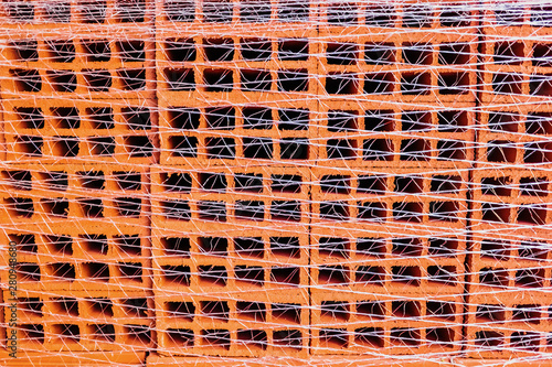 Close-up of a stack of packed bricks, to use as background in architectural themes. photo