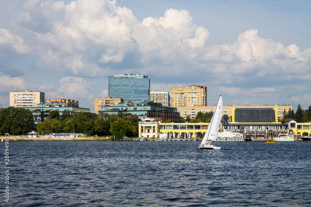  Moscow / Russia - July, 27, 2019: sailing boat with white sails on Khimki reservoir on a cloudy summer day