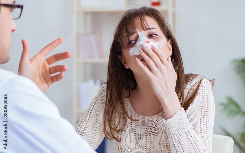 Male doctor talking to patient with nose operation surgery Male doctor talking to patient with nose operation surgery