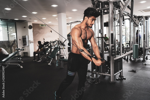 Bodybuilder Is Working On His Chest With Cable Crossover In Gym. Scream for motivation