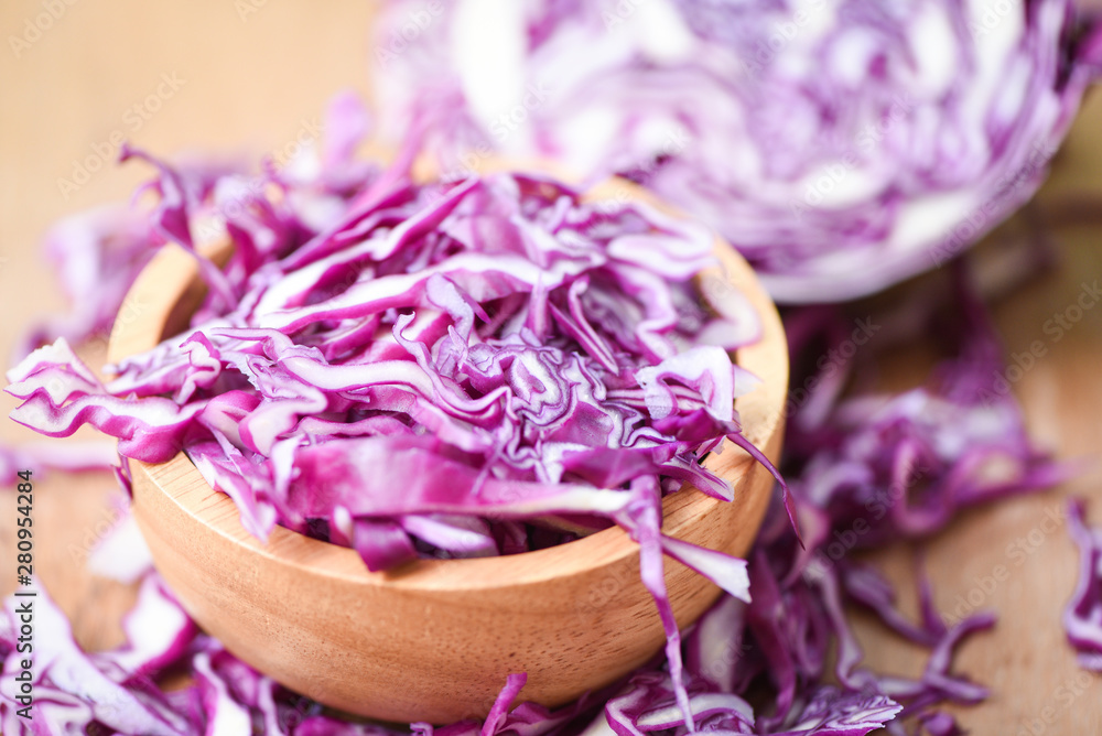 Cabbage purple - Shredded red cabbage slice in a wooden bowl top view Cabbage purple - Shredded red cabbage slice in a wooden bowl top view